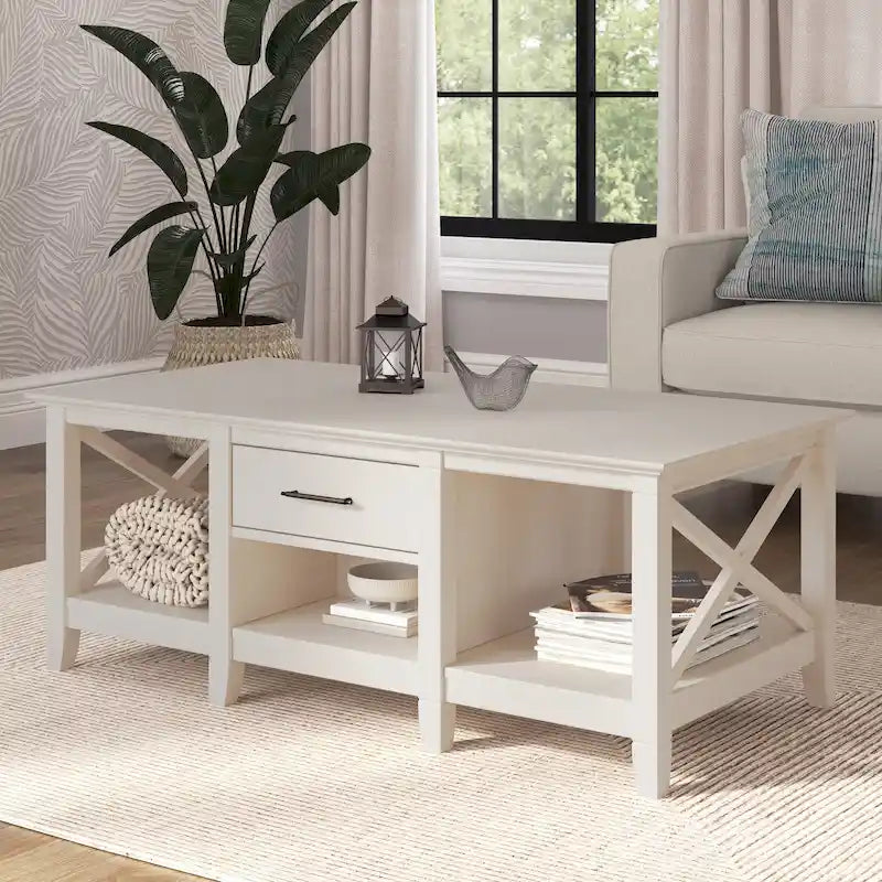 Mesa de centro blanca de estilo rústico con cajón y almacenamiento abierto, mesa para sala de estar con estructura lateral en forma de X